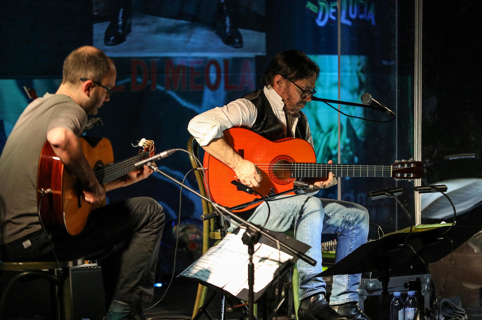 guitarists playing music live onstage