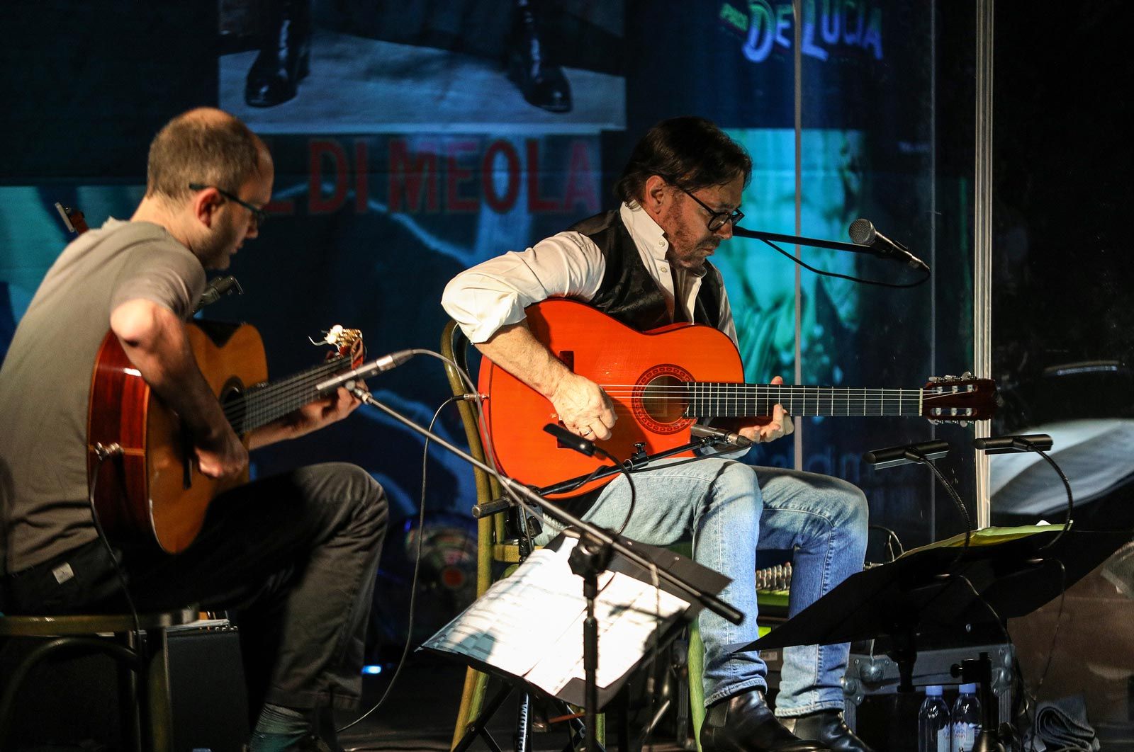guitarists playing music live onstage